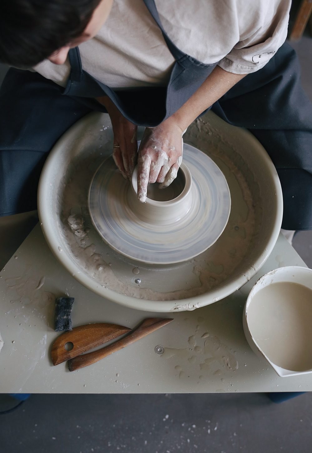 working-on-a-potter-s-wheel-with-a-clay-in-a-pottery-studio-clay-jug.jpg working-on-a-potter-s-wheel-with-a-clay-in-a-pottery-studio-clay-jug.jpg